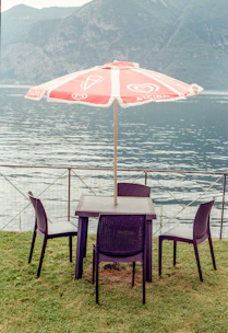 Outdoor patio setup with elegant chairs and a folding tent.