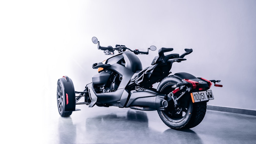 a black motorcycle parked in a white room