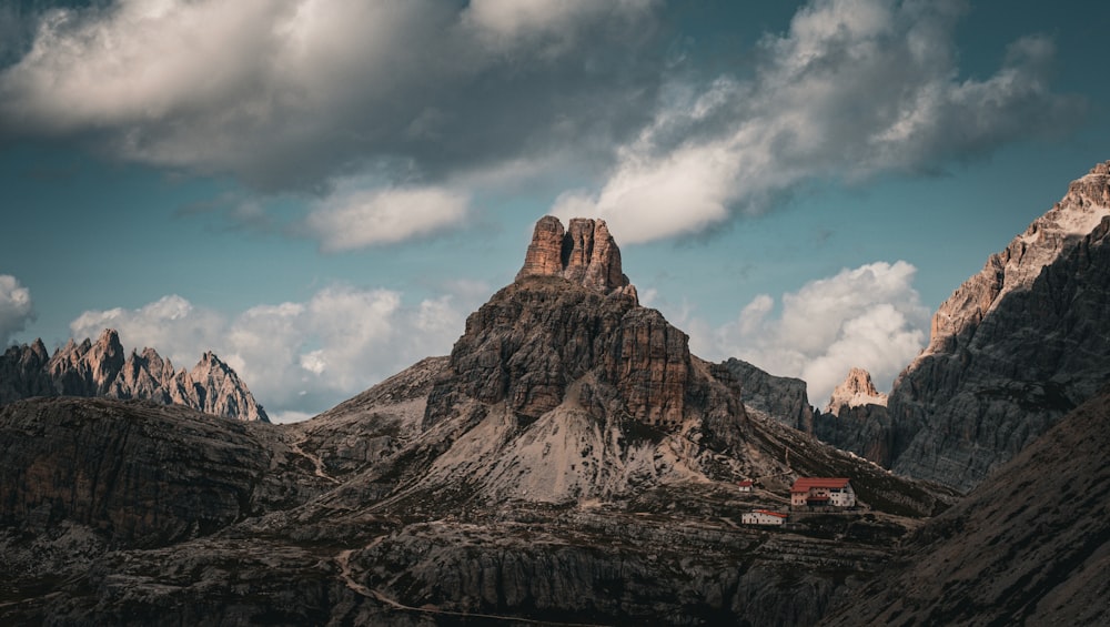 a mountain range with a house in the foreground