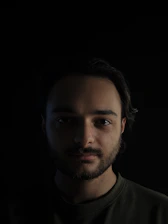 Warm ambient lighting highlighting a premium beard grooming session with precise detailing.