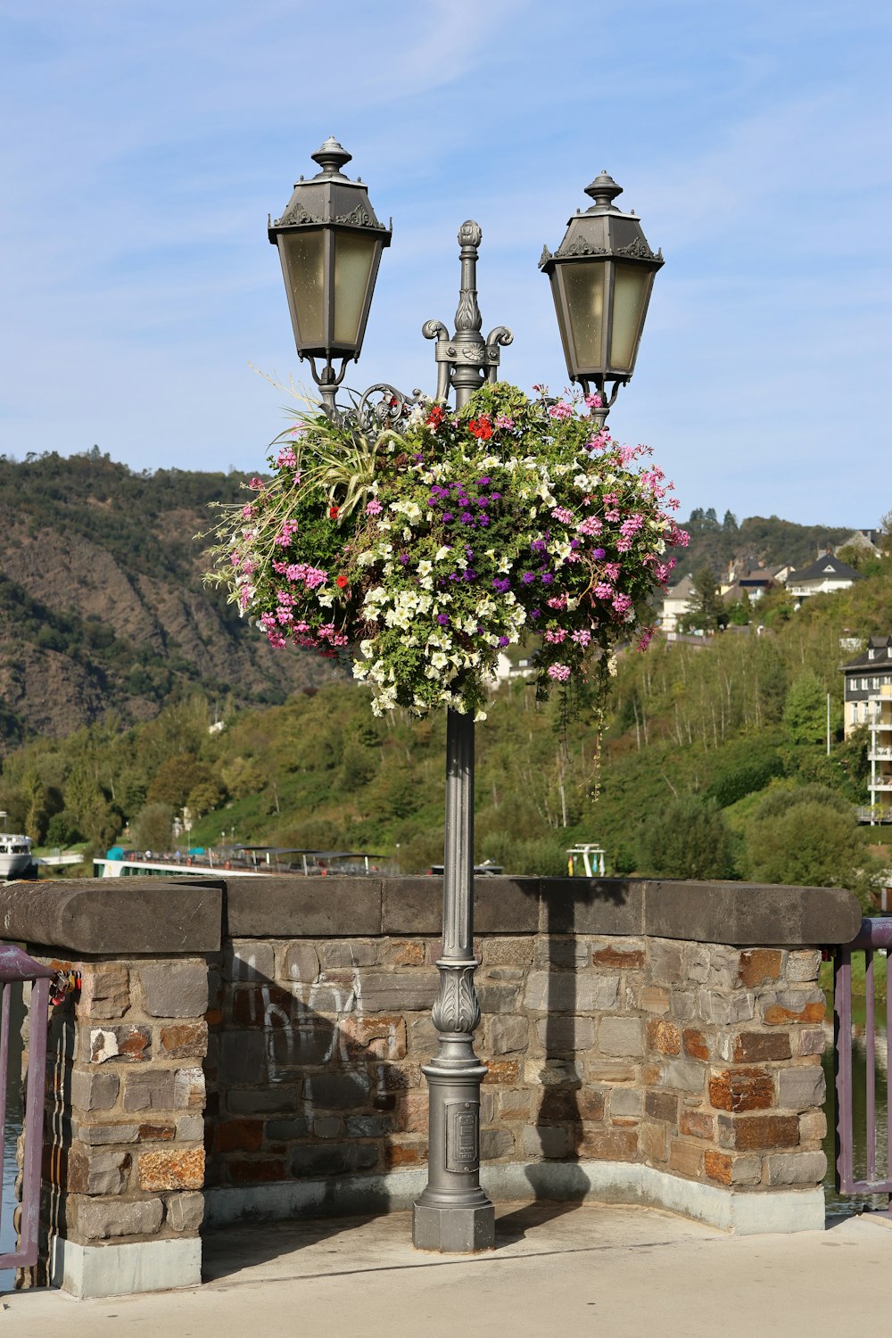 a lamp post with a bunch of flowers on it