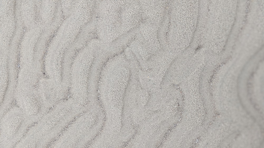 a close up view of sand and water