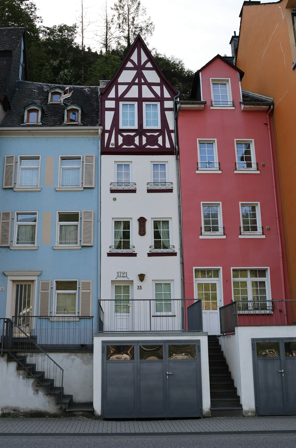 a row of multicolored buildings with a staircase leading up to them