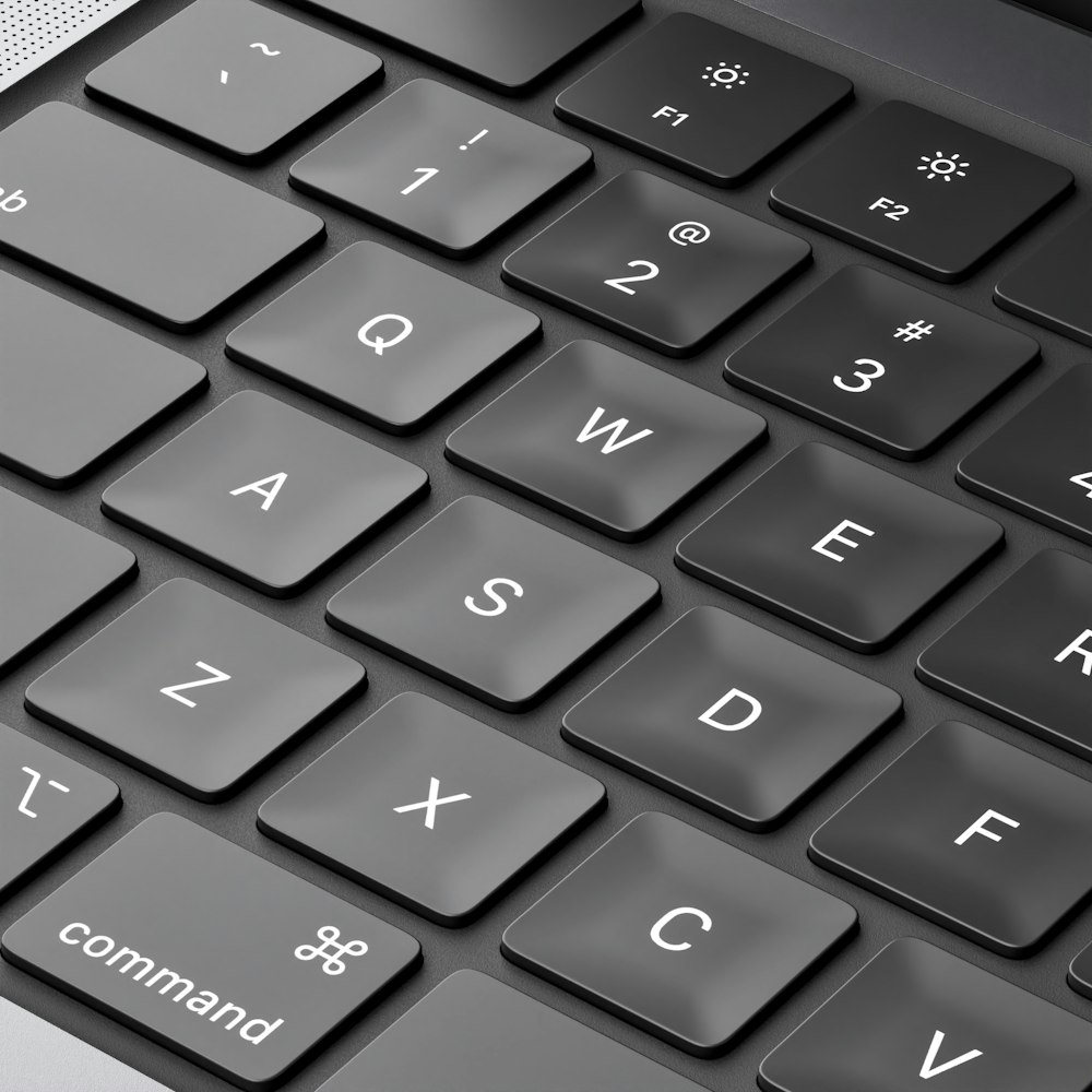 a close up of a computer keyboard with a black and white background