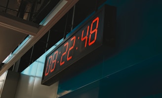 Close-up of a digital clock displaying peak slot times on a sleek interface.