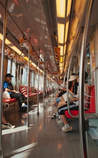 A cozy train interior with comfortable seats and passengers enjoying the ride.