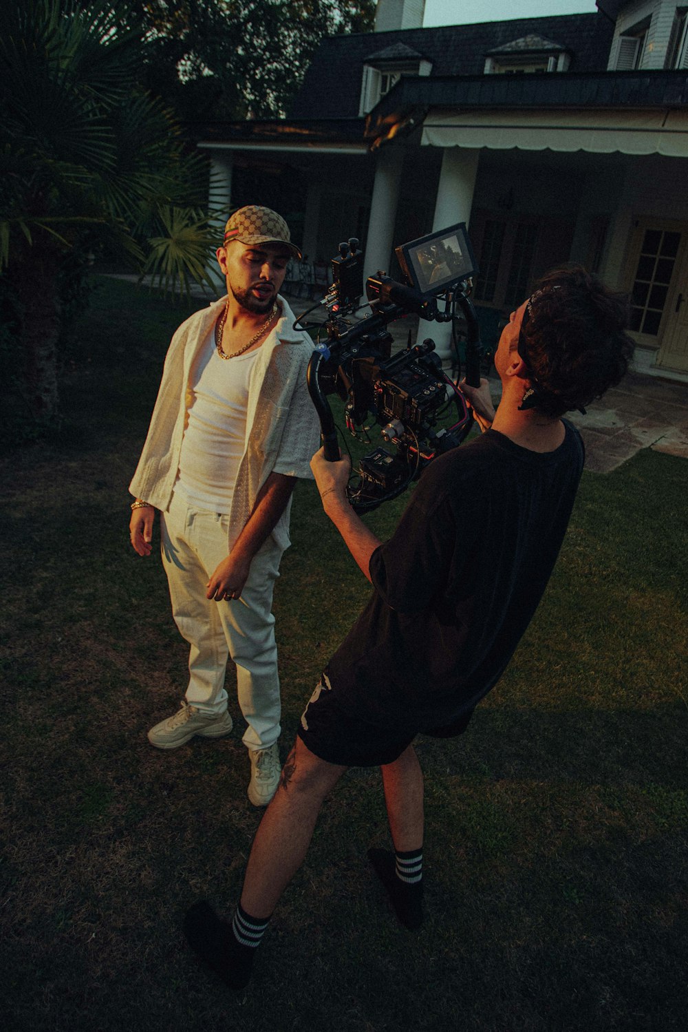 a man standing next to another man holding a camera