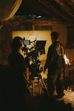 a couple of people standing in front of a camera