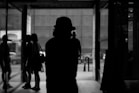 a black and white photo of a person in a hat