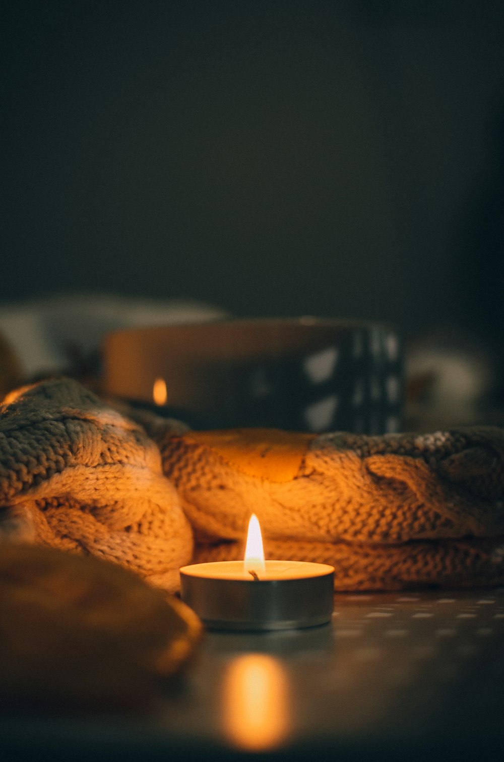 a lit candle sitting on top of a table