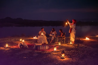 An intimate outdoor dining setup with warm lanterns under a starry Ladakhi sky.