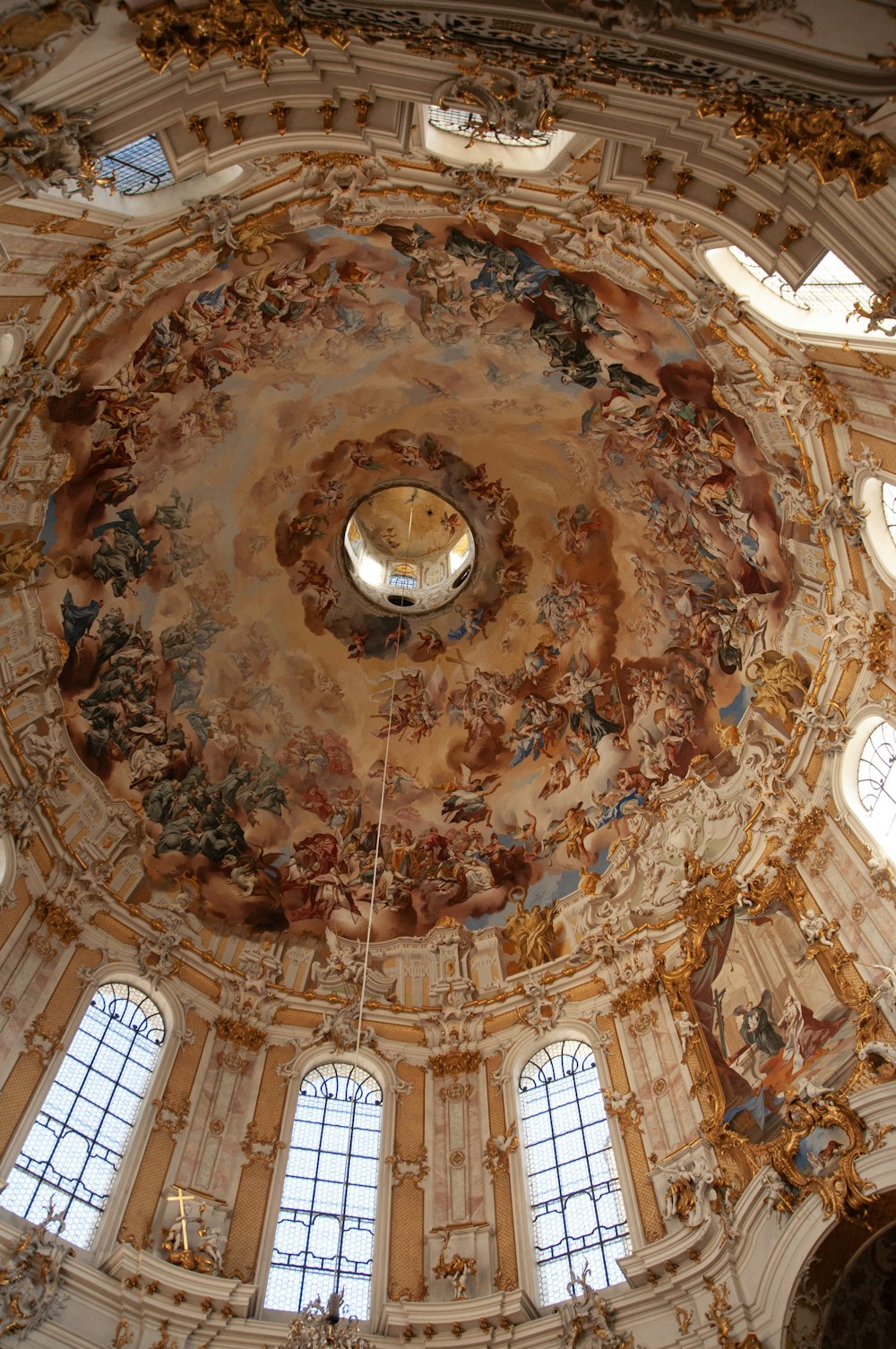 the ceiling of a large building with many windows