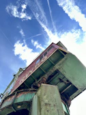 Wide shot of a large metal structure being inspected outdoors on a sunny day.