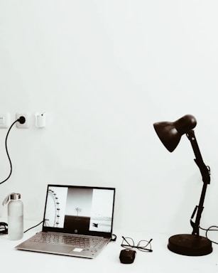 A black-themed minimalist workspace with photography equipment softly lit against a dark background.