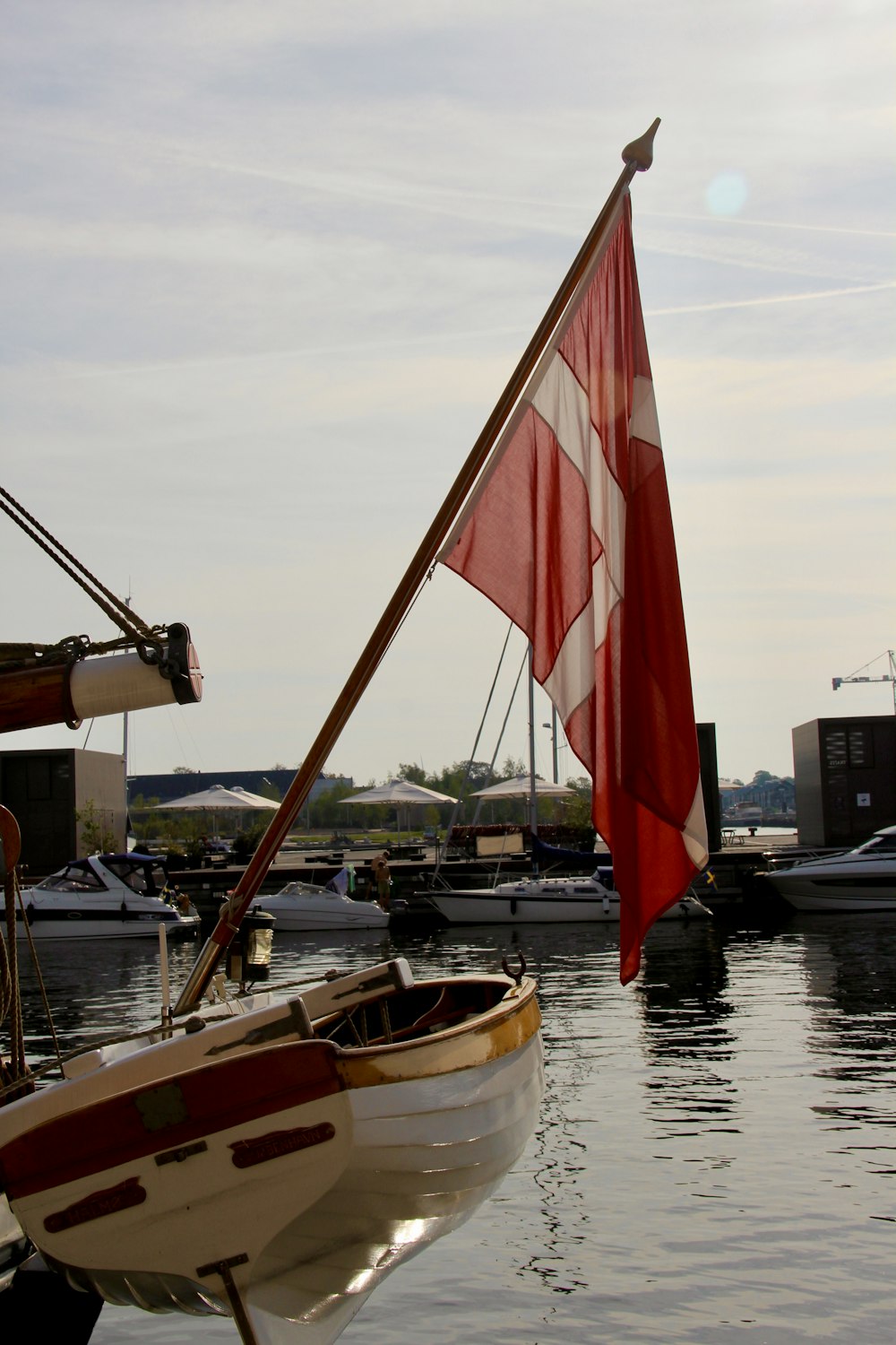 a red and white boat sitting in the water