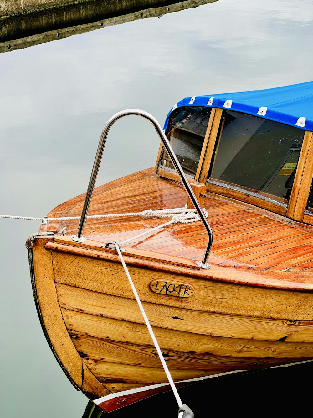 a small wooden boat tied to a dock