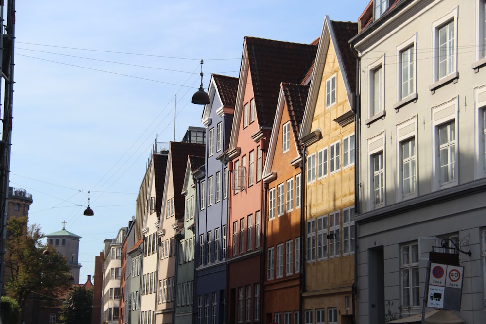 a row of multi - colored buildings on a city street