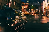 Night view of Luzern city streets with a nova-taxi car passing by.