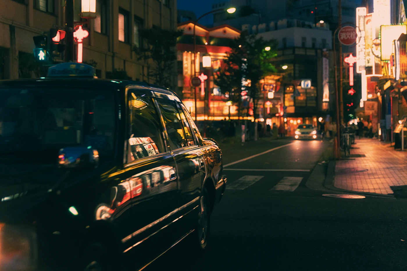 Taxi travelling through a city at night