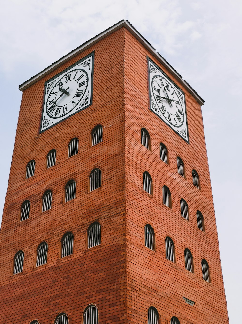 a tall brick building with a clock on the top of it