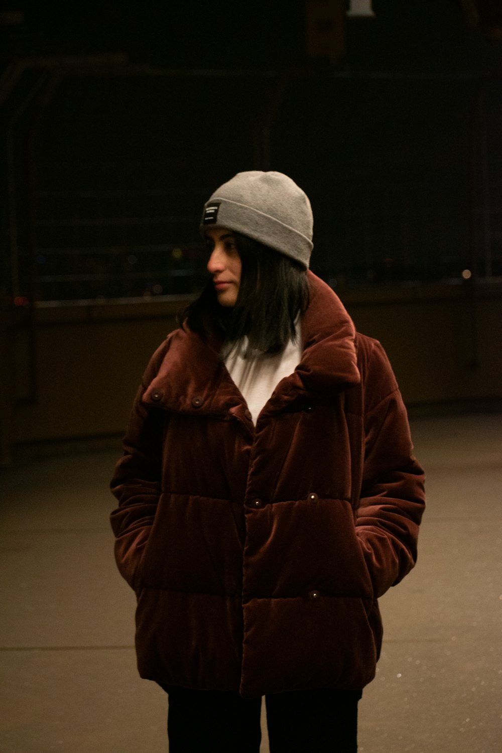 a woman in a brown jacket and a gray hat