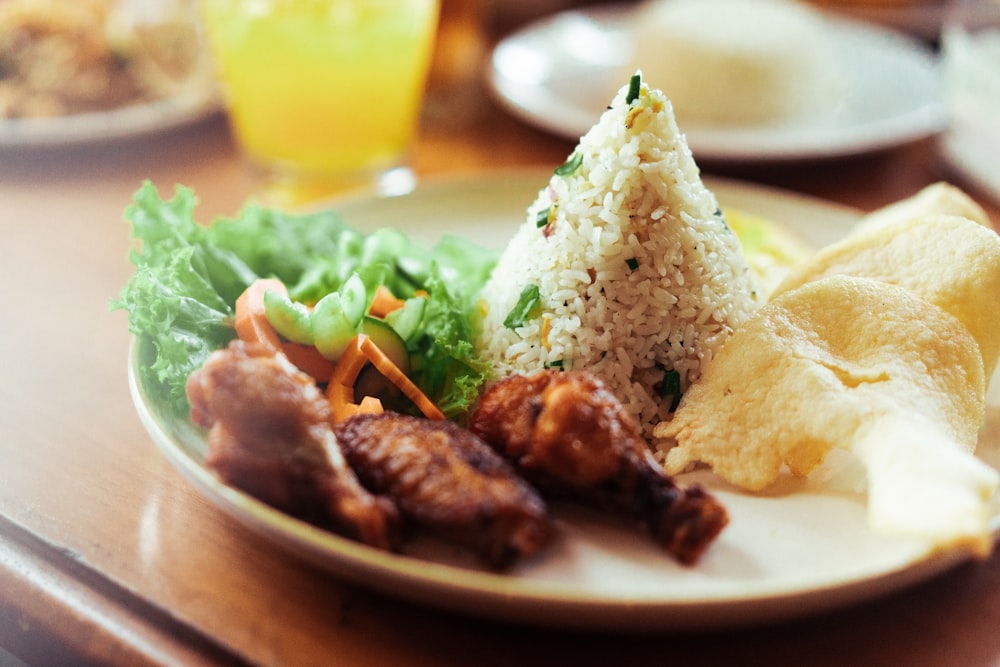 a white plate topped with meat and veggies