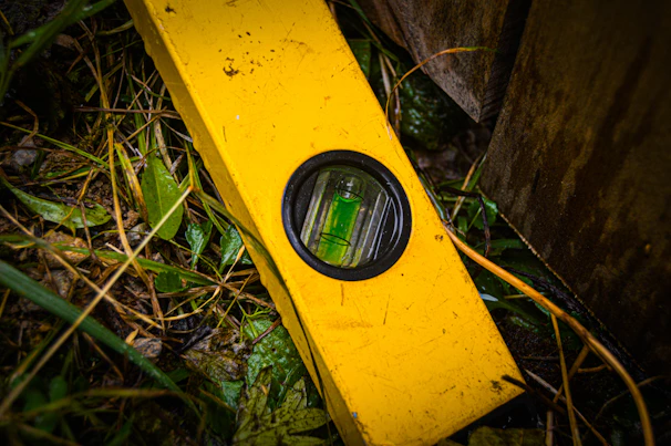Technician inspecting structural damage with moisture meter after flood cleanup.