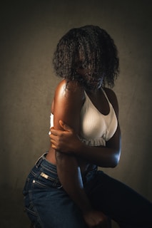 a woman in a white tank top hugging a man