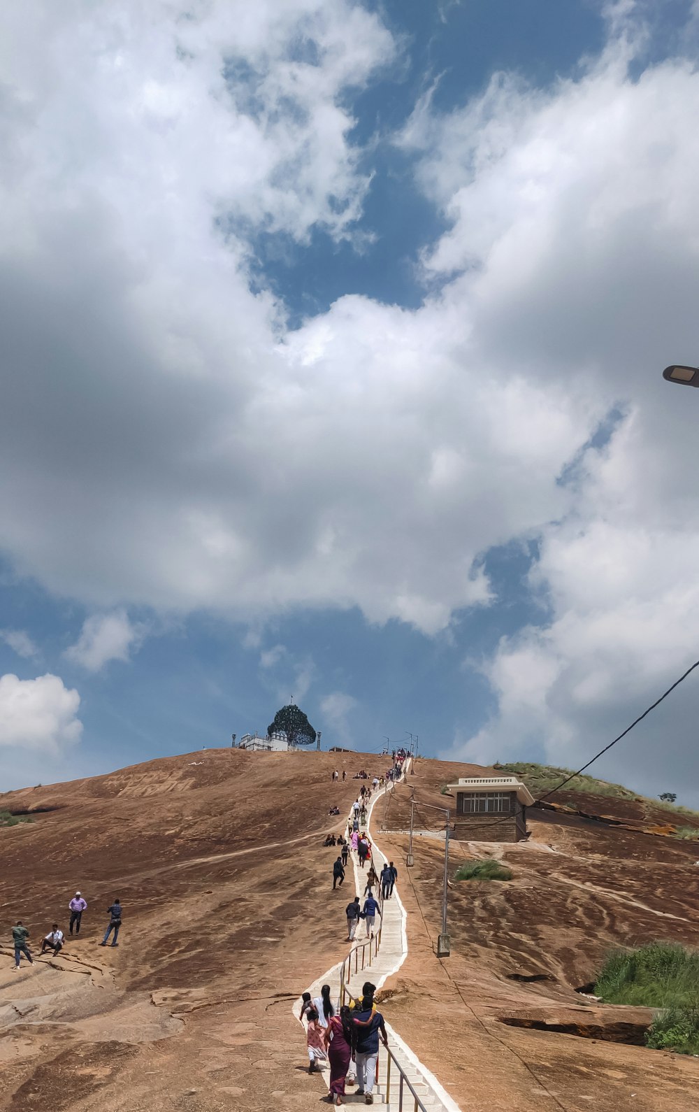 a group of people walking up a hill