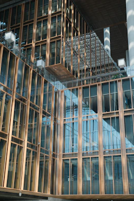 Contemporary commercial property facade with sleek glass and gold accents.