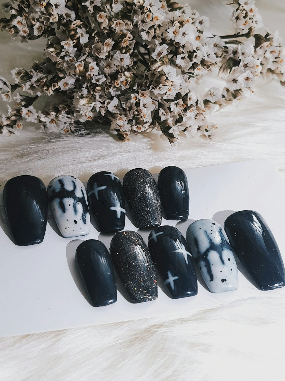 a bunch of black and white nails sitting on top of a table