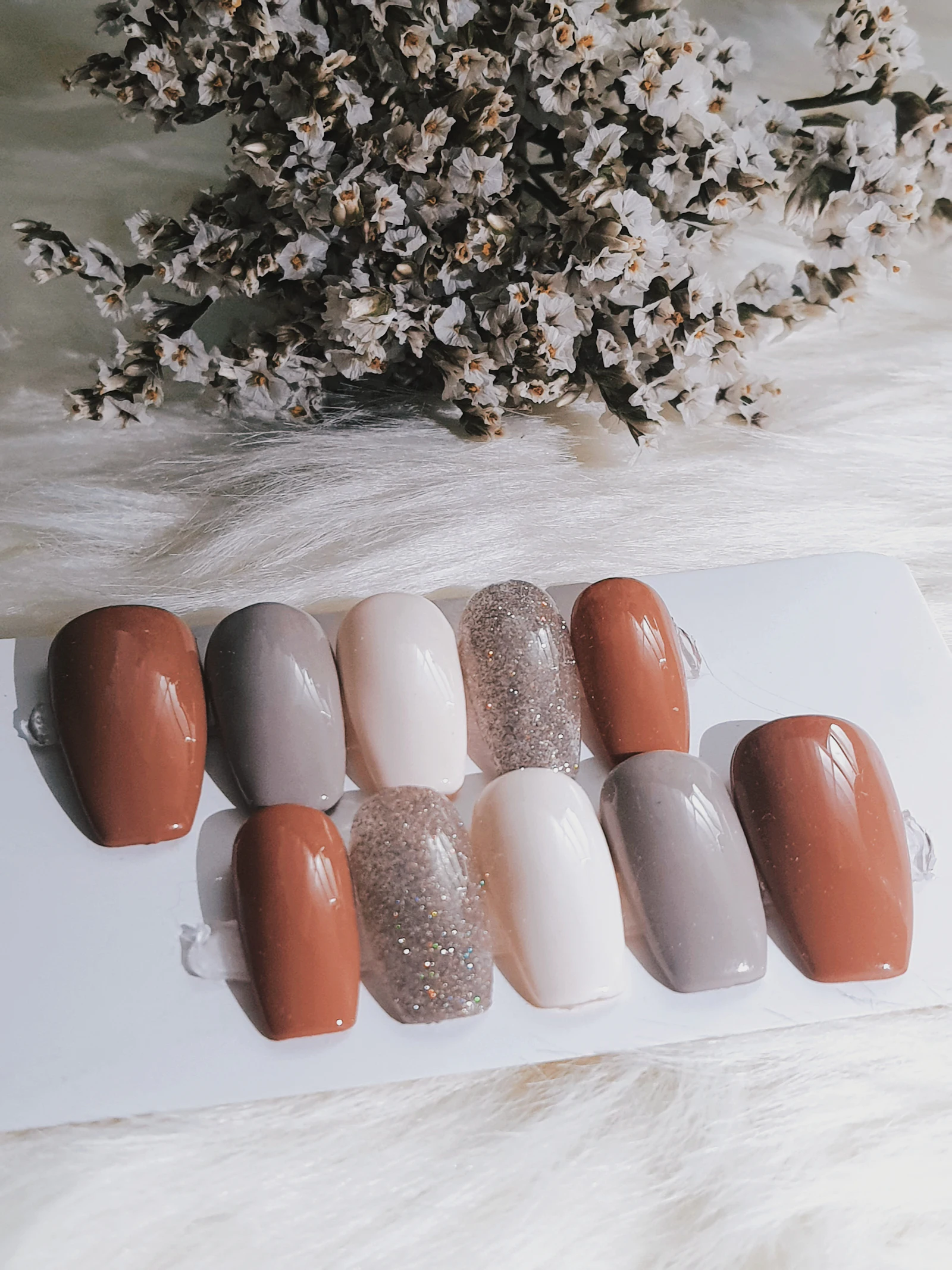Six nail color swatches in soft shades