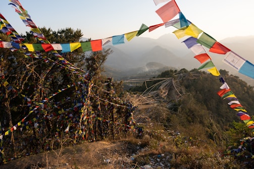 A serene mountain landscape in Bhutan with prayer flags fluttering in the breeze.