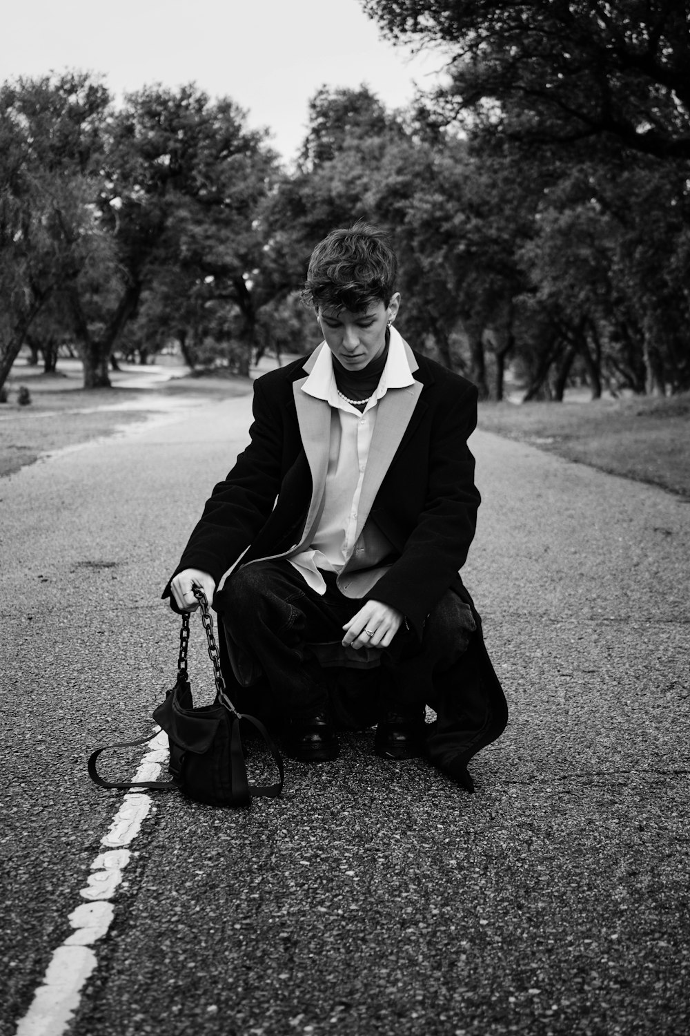 a man kneeling down on the side of a road