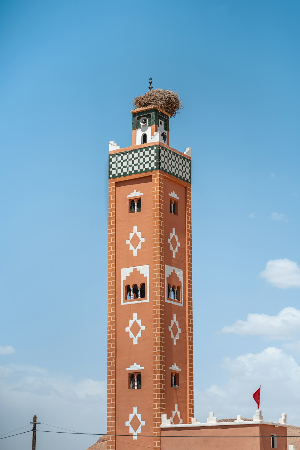 a tall brick tower with a clock on top