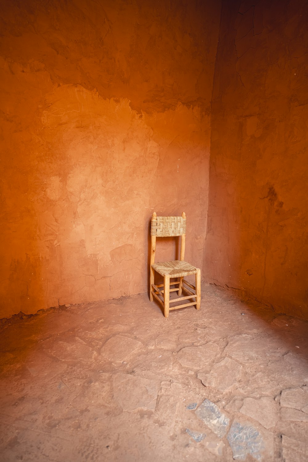 a chair sitting in a corner of a room