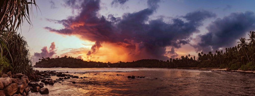 the sun is setting over a tropical beach