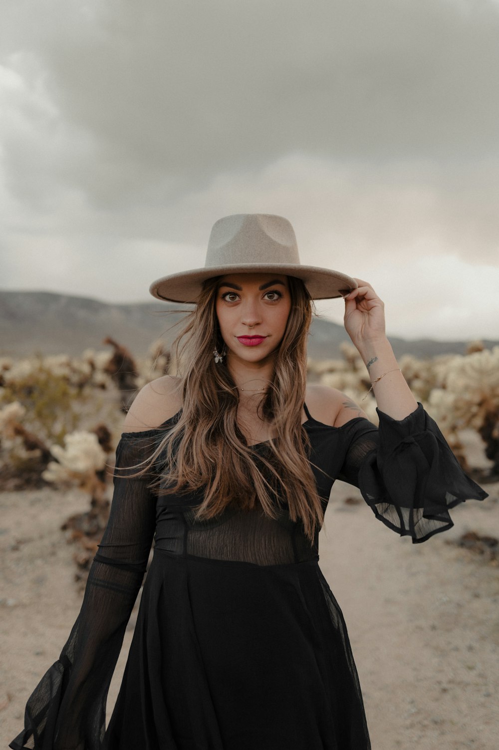 a woman in a black dress and a hat