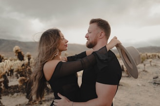 a man and a woman embracing in the desert