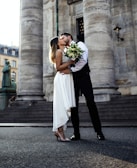 A beautiful wedding scene with a couple sharing a kiss.