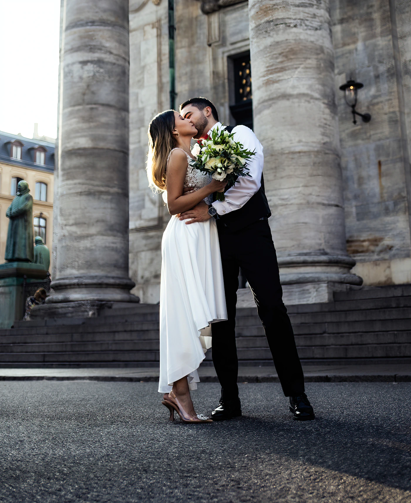 Couple celebrating after their Quebec City elopement in the Petit-Champlain quarter with the cobblestone street and the stone buildings of the historic Lower Town around them