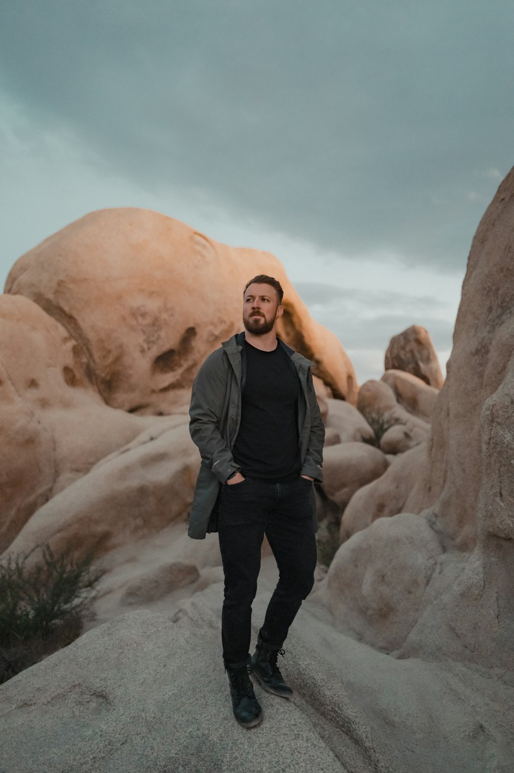 a man standing on top of a rock formation