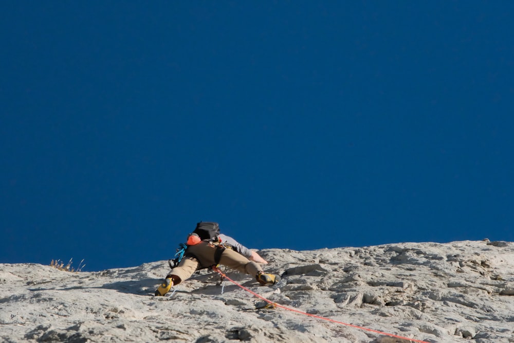 a man climbing up the side of a mountain