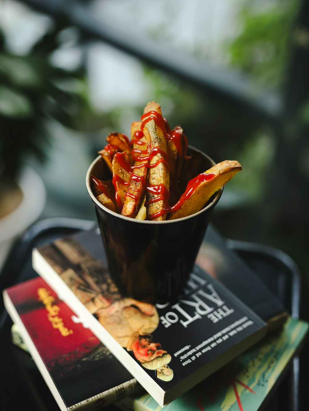 a cup filled with french fries sitting on top of a table