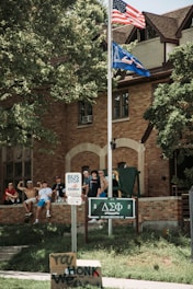A fraternity group proudly wearing their custom dudebro shirts at a campus event.