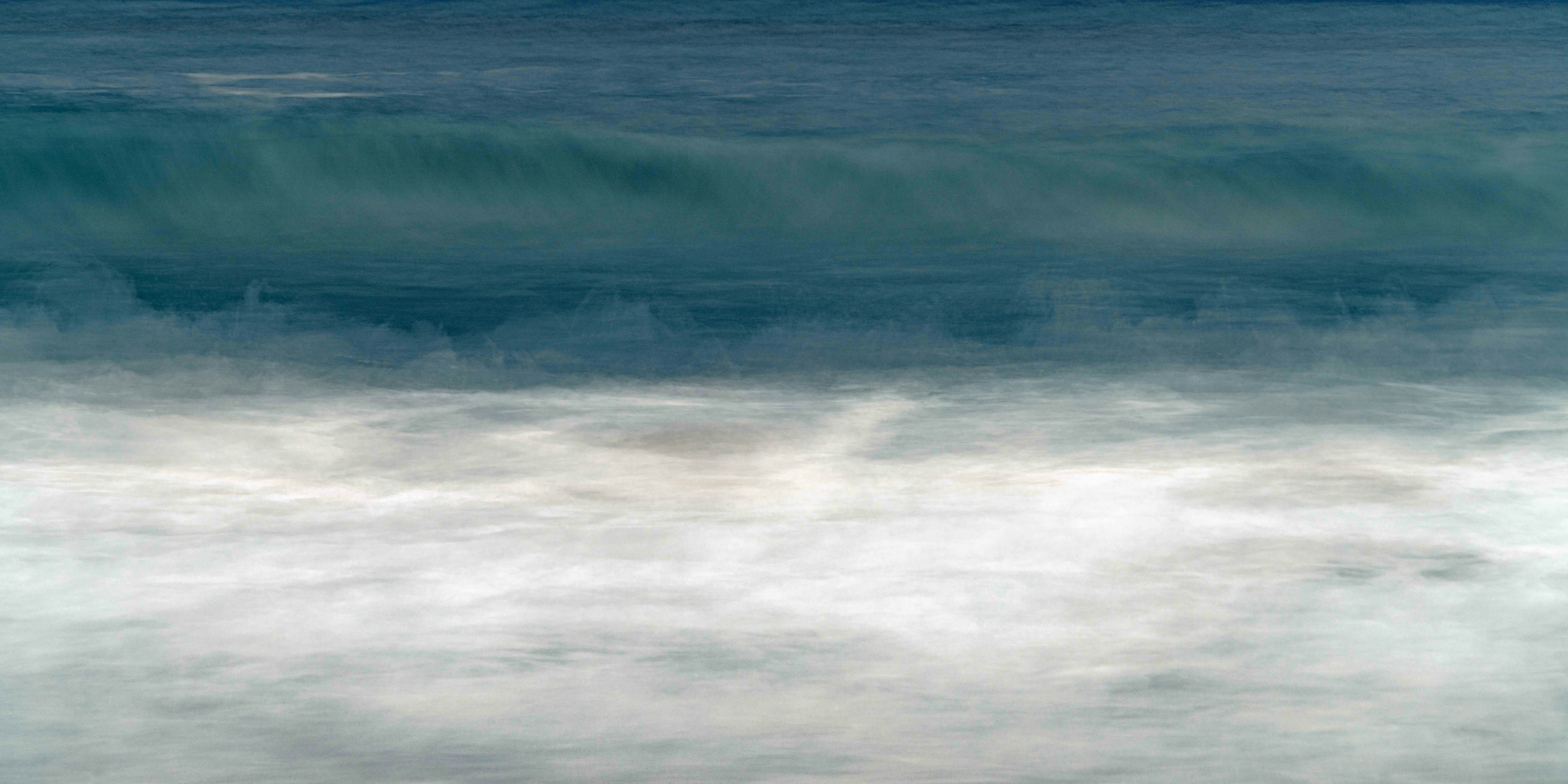a person riding a surfboard on a wave in the ocean