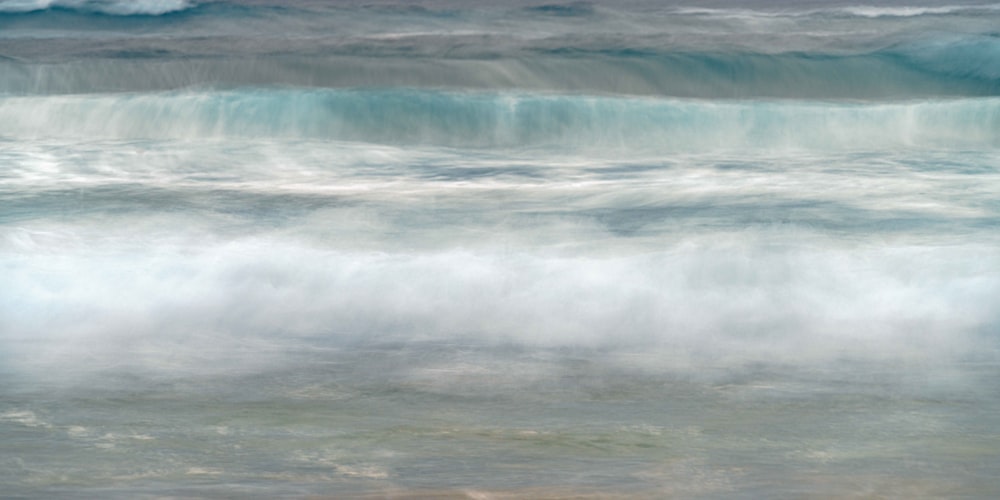 a person riding a surfboard on a wave in the ocean