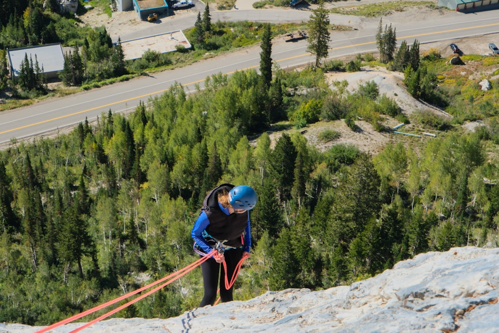 a man climbing up the side of a mountain