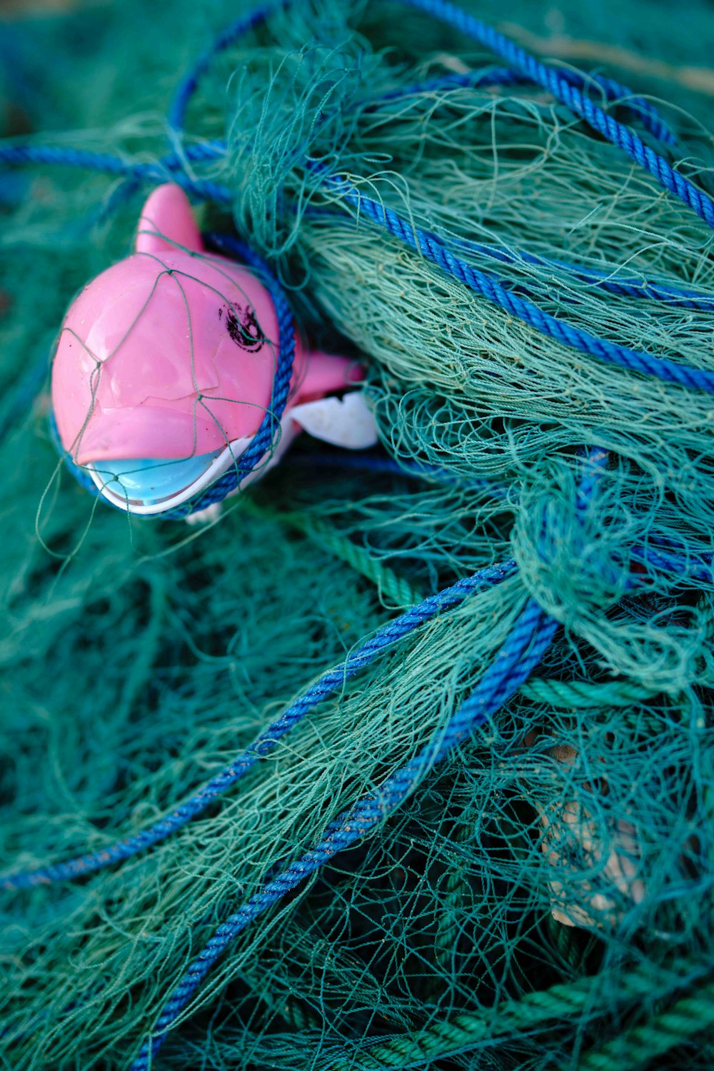 a pink toy in a green fishing net