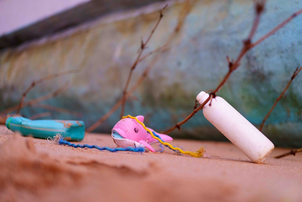 a toy car and a baseball bat laying on the ground